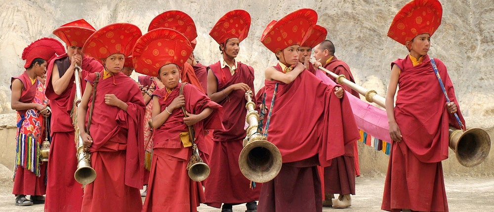 Group of young monks with Dungchen (colossal trumpets)